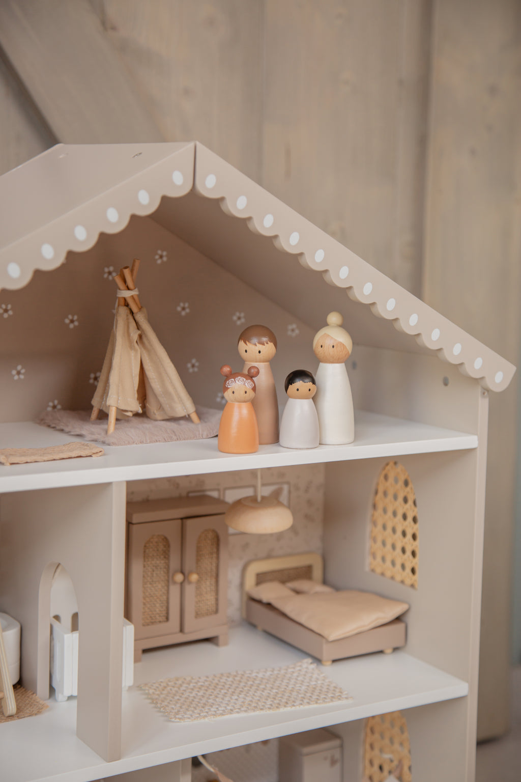 Maison de poupée en bois avec mobilier et figurines enfants vue de l'étage supérieur